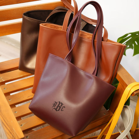 a group of three bags sitting on top of a wooden chair