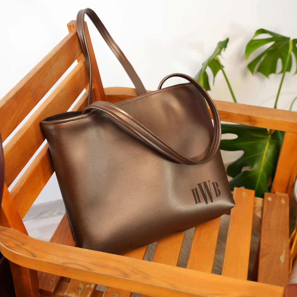 a brown purse sitting on top of a wooden chair