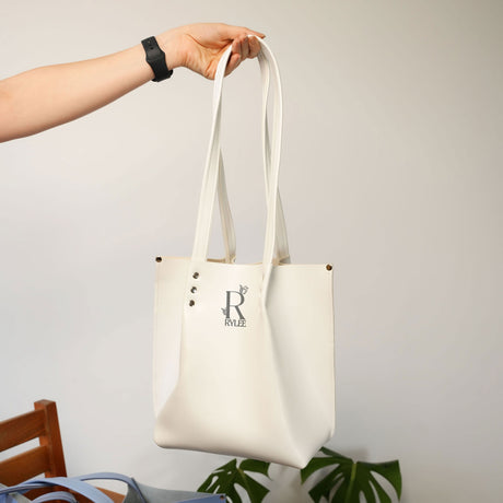 an orange purse sitting on top of a wooden chair