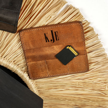 a brown leather wallet sitting on top of a table