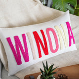 a pillow with the word now on it