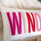 a decorative pillow with the word wind on it