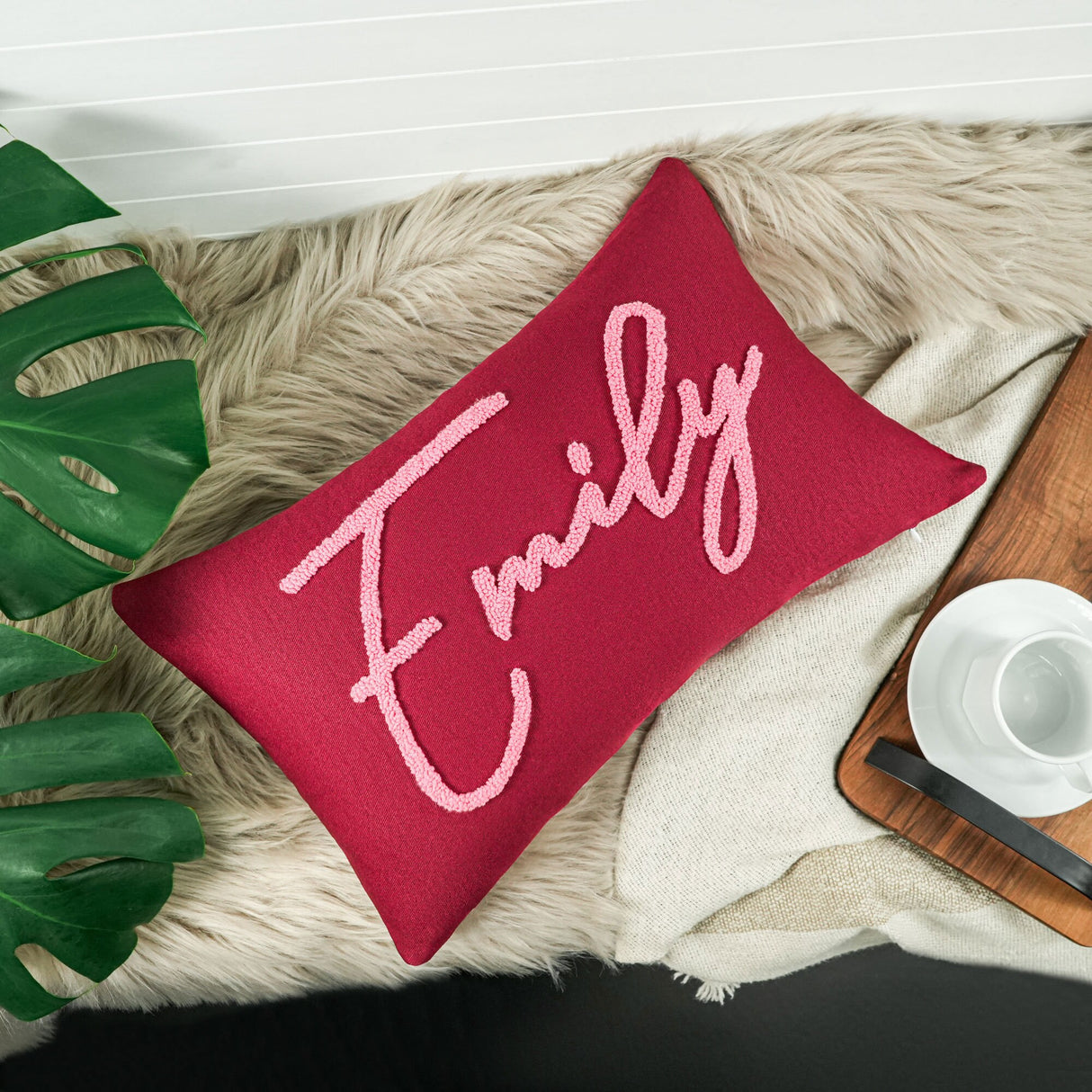 a red pillow with the word family on it