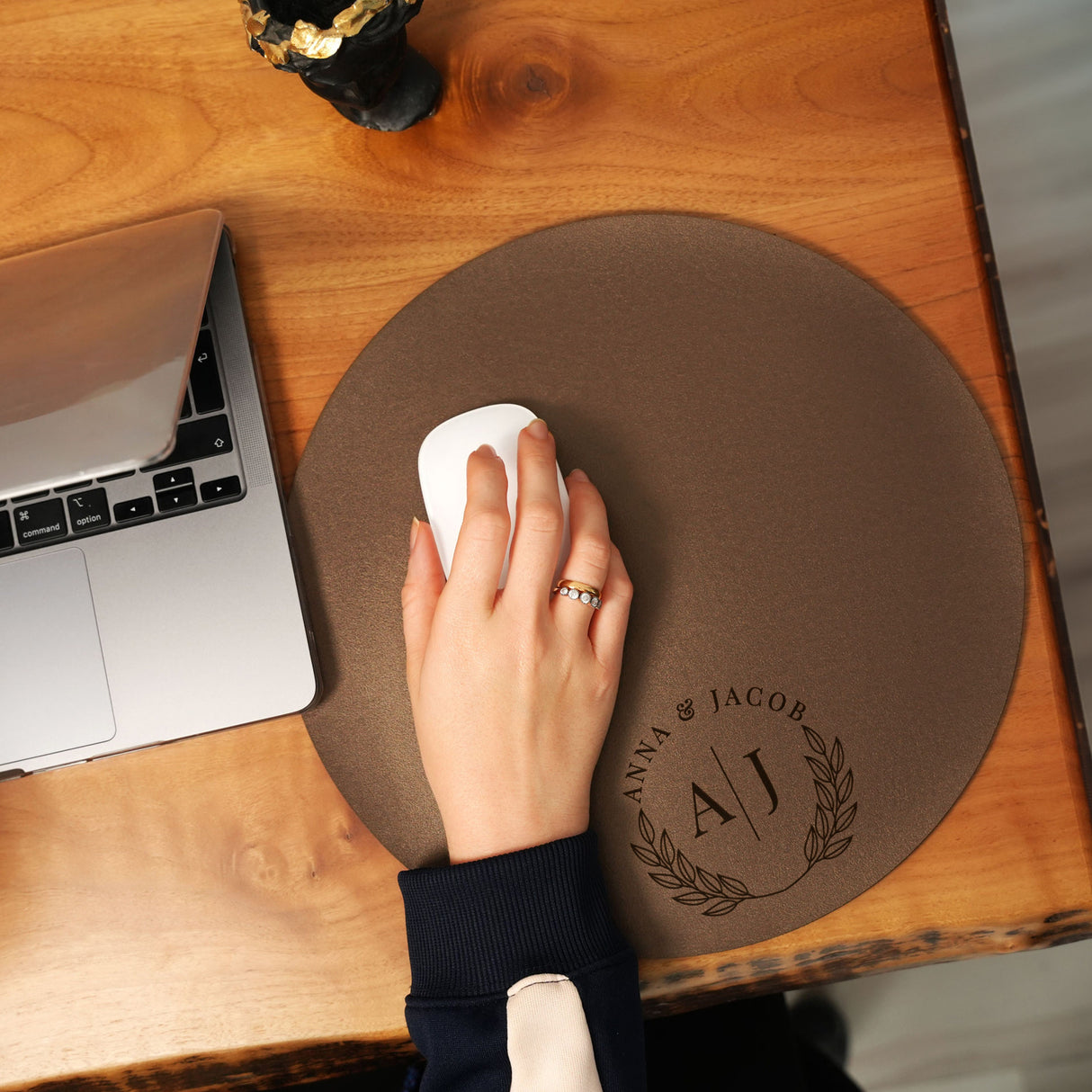 a person using a mouse on a wooden table