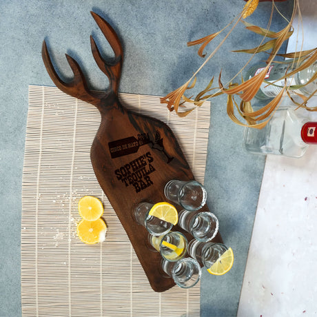 a wooden tray with glasses and lemons on it