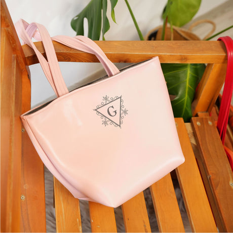 a pink purse sitting on top of a wooden chair