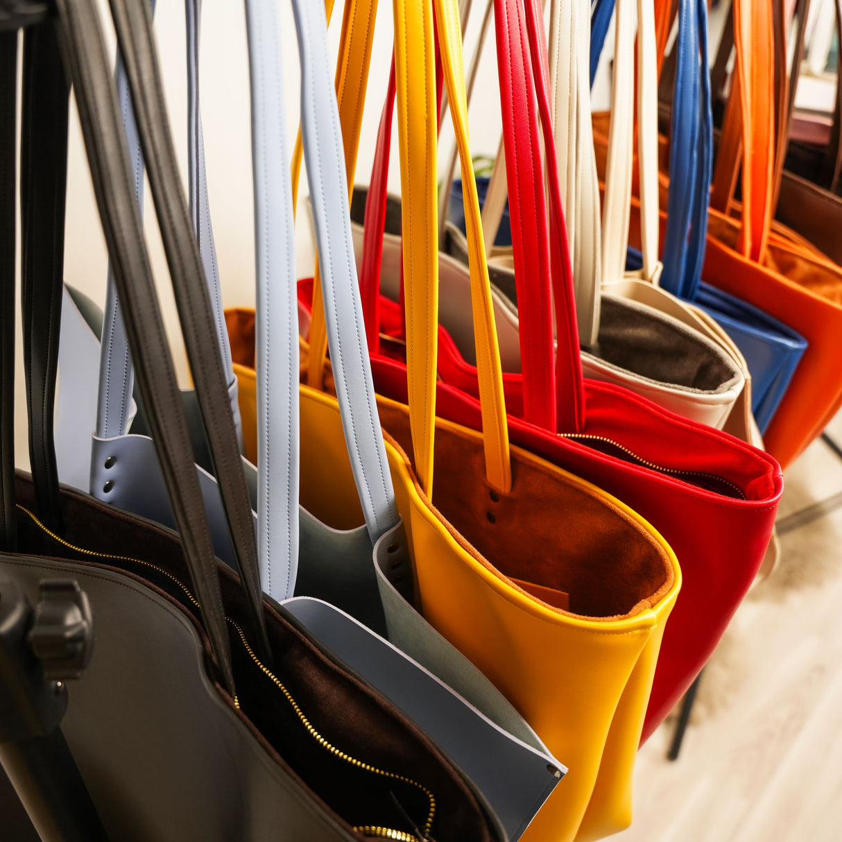 a bunch of purses hanging on a rack