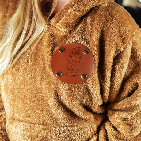 a woman wearing a brown jacket with a leather button on it