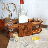 a bottle of alcohol sitting on top of a wooden tray