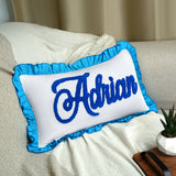 a pillow with a name on it sitting on a couch