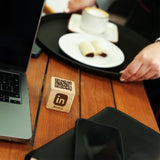 a laptop computer sitting on top of a wooden table