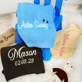 a blue chair with personalized socks and a personalized pillow