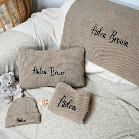 a teddy bear sitting on top of a bed next to pillows