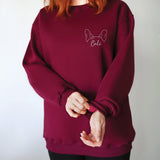 a woman with red hair wearing a red sweatshirt