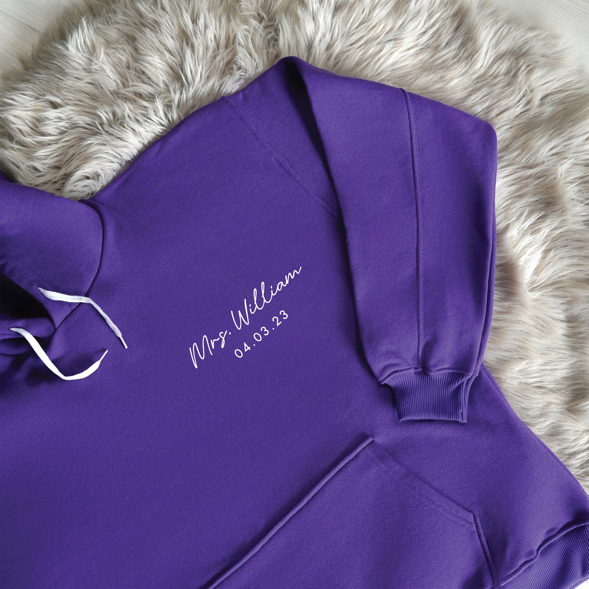 a purple hoodie with a white name on it