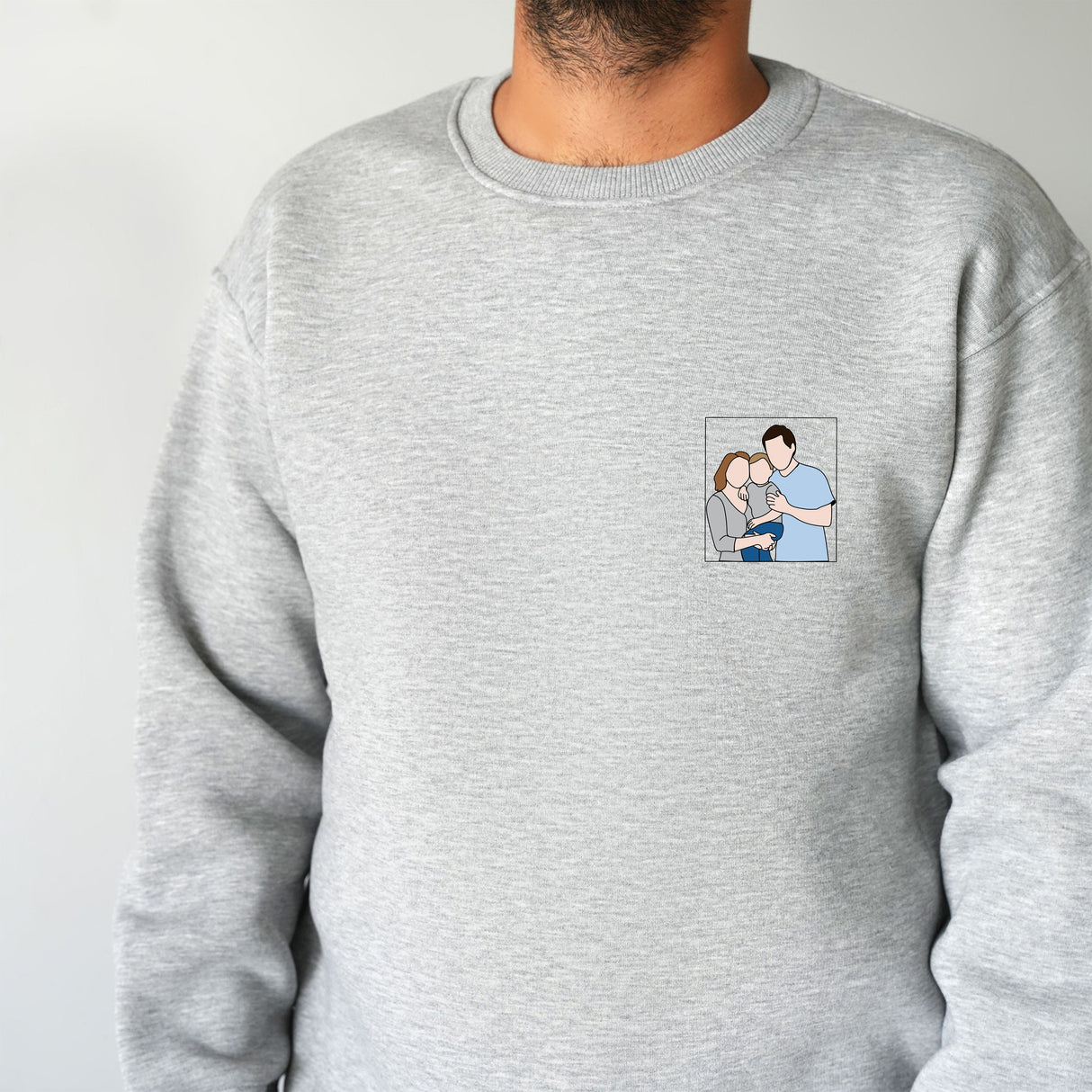 a man wearing a grey sweatshirt with a picture of a man and a woman on