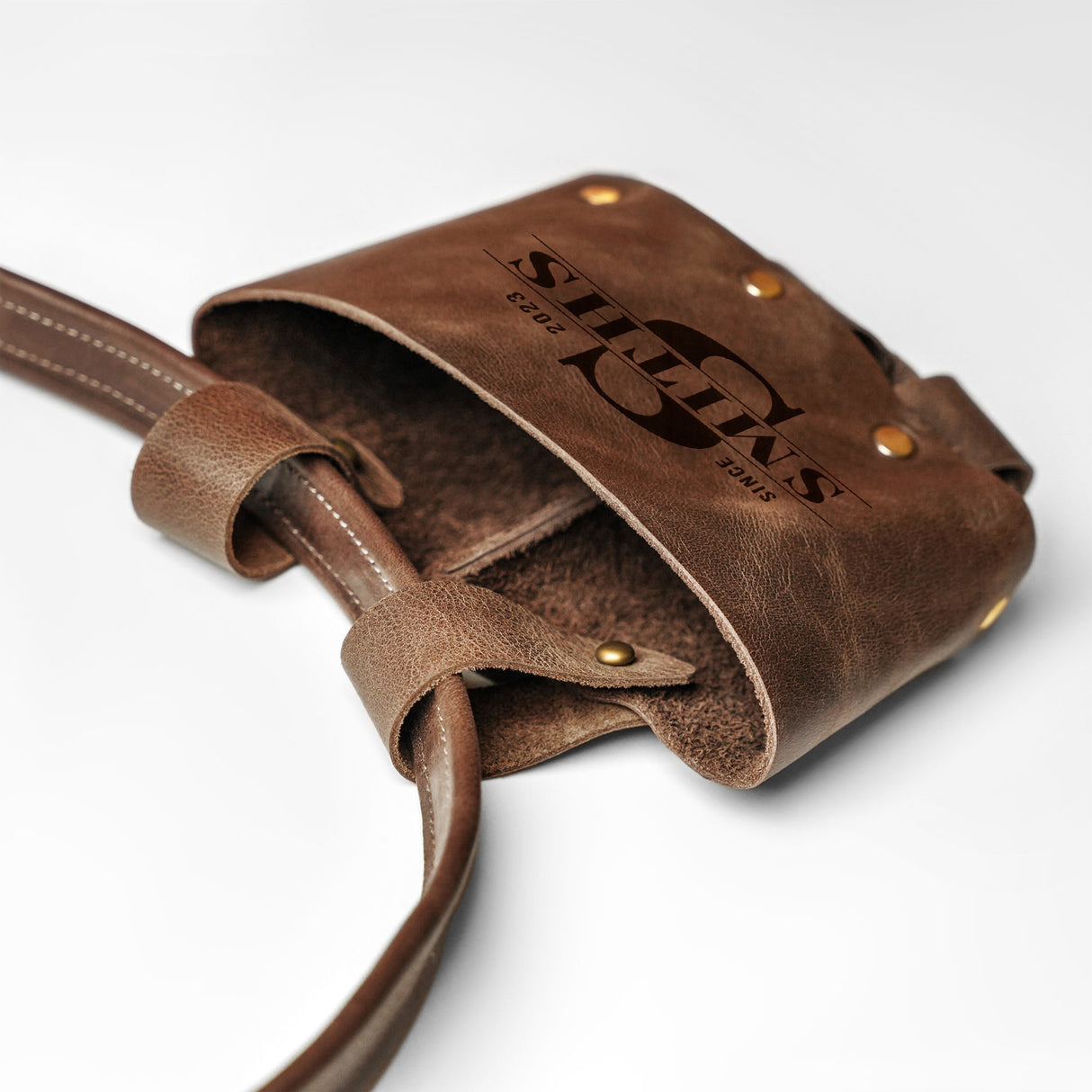 a brown leather purse with a brown strap