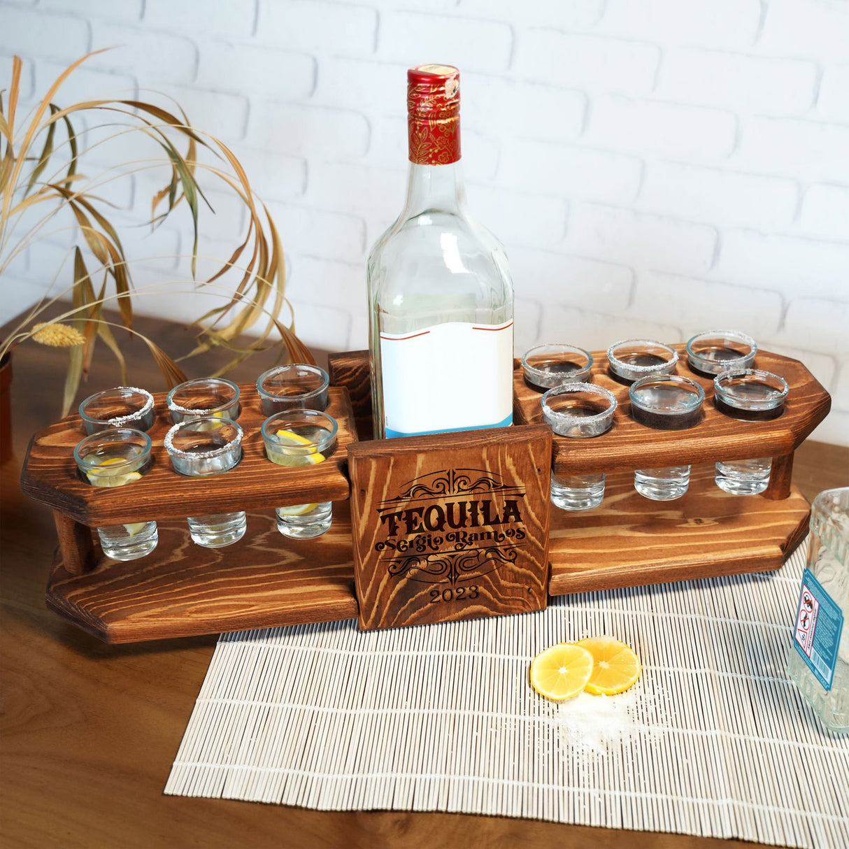 a bottle of liquor sitting on top of a wooden tray