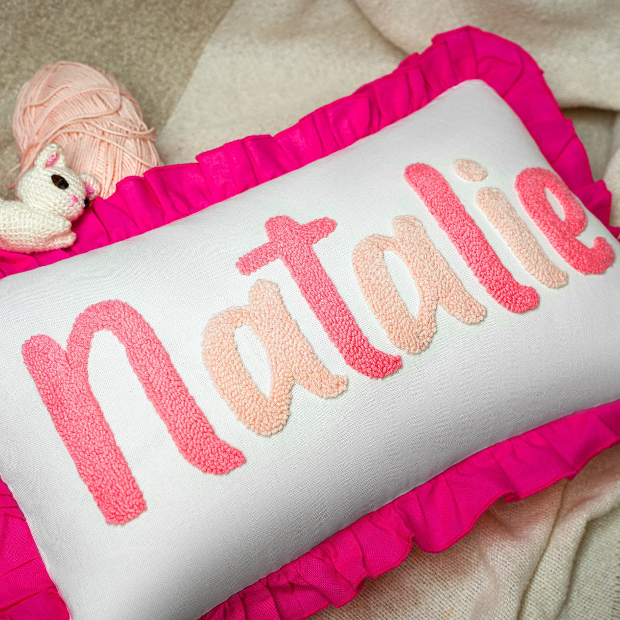 a white pillow with the word natalie on it