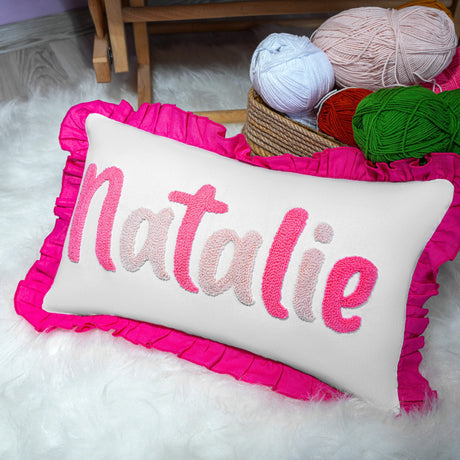 a pink pillow with a name on it