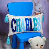 a white teddy bear sitting next to a blue chair