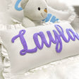 a teddy bear sitting next to a pillow that says i am i am