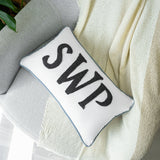 a pillow with the word swp on it sitting on a chair
