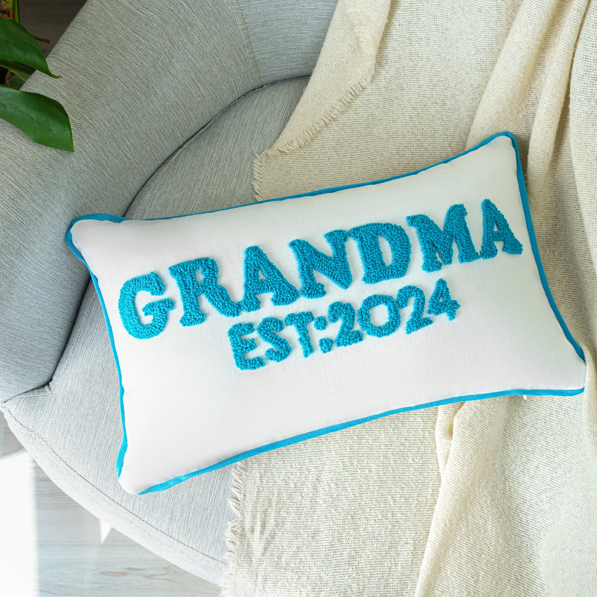 a blue and white pillow that says grandma est 2012