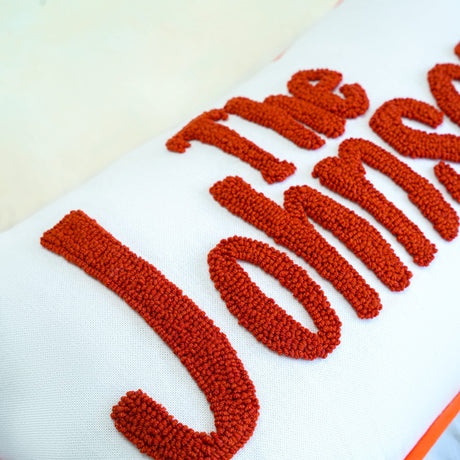 a close up of a pillow with a name on it