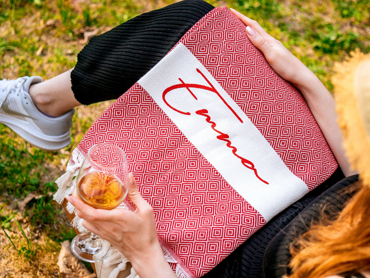 a woman holding a book and a glass of wine