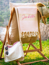 a beach chair with a personalized towel on it