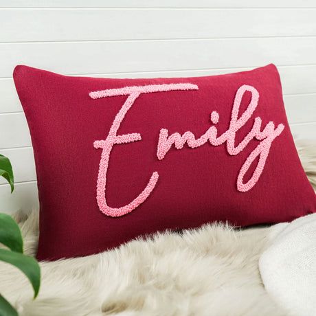 a red pillow with the word family on it