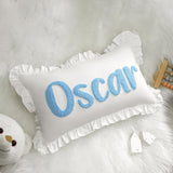 a stuffed animal next to a pillow with the word oscar on it