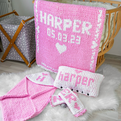 a crocheted blanket, mitts, and blanket on a white rug