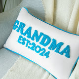 a blue and white pillow with a name on it