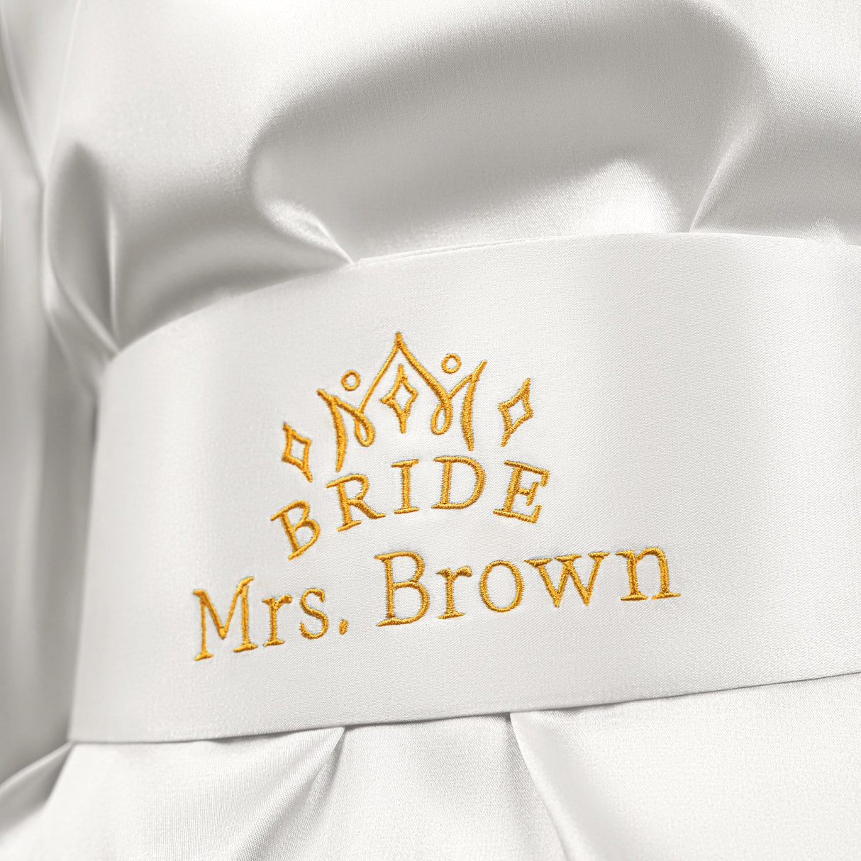 a close up of a white shirt with a crown on it