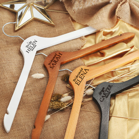 a set of three personalized wooden clothes hangers