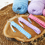 a group of crocheted items sitting on top of a wooden plate