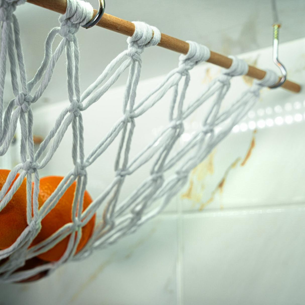 a close up of a rope net with oranges in it