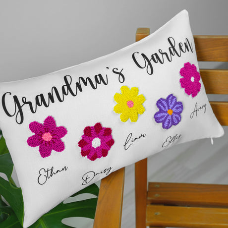 a white pillow with colorful crocheted flowers on it