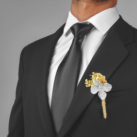 a man in a suit with a boutonniere on his lapel