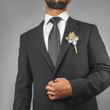 a man in a suit with a boutonniere on his lapel