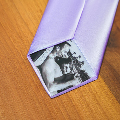 a purple tie with a picture of a man and a woman