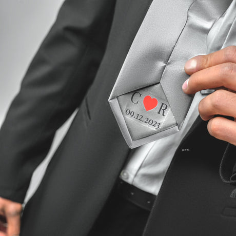 a close up of a person wearing a suit and tie