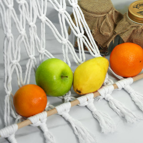 a group of fruit sitting on top of a white net