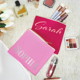 a pink personalized cosmetic bag with personalized name on it