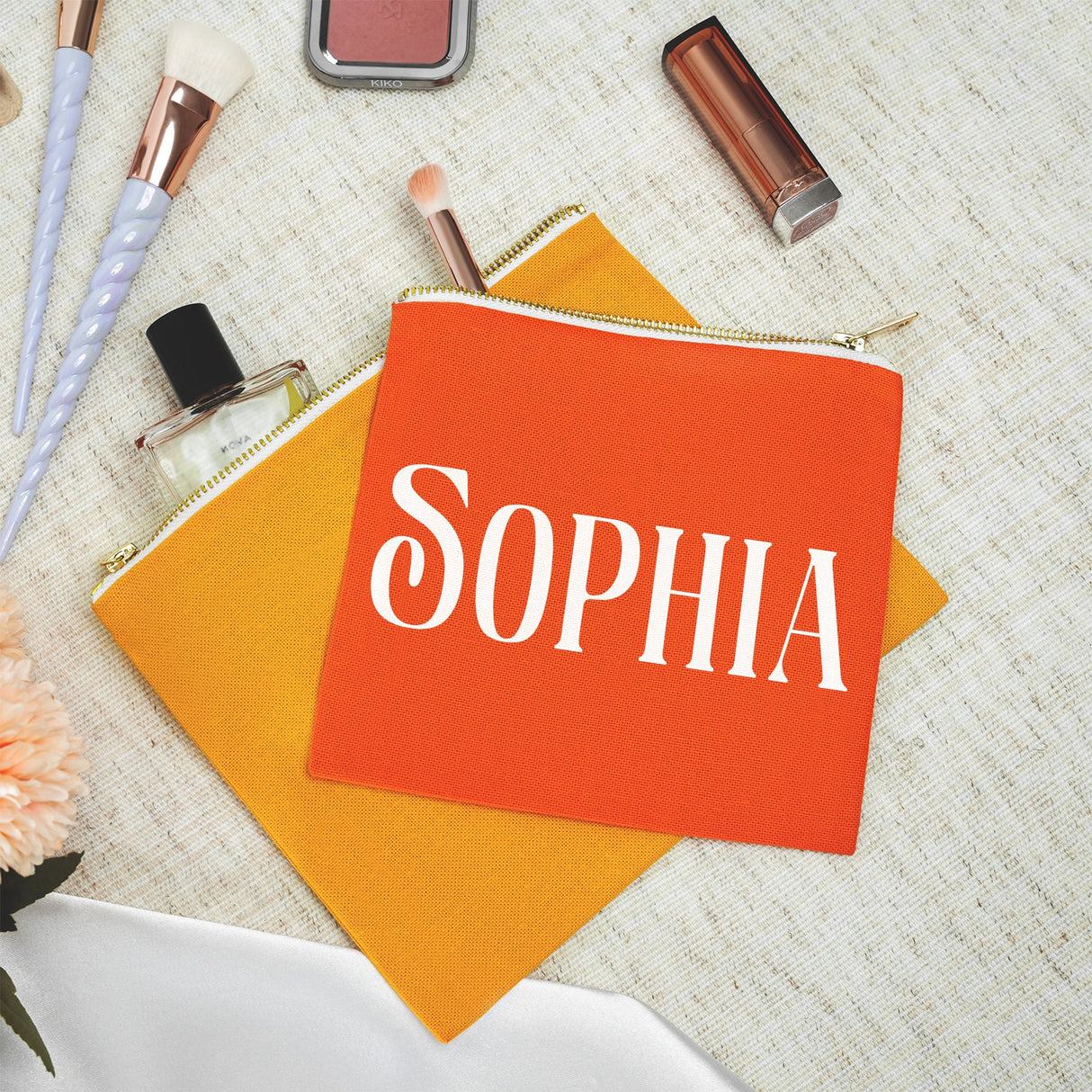 a small orange bag with the word sophia on it