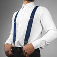 a man wearing a white shirt and blue suspenders