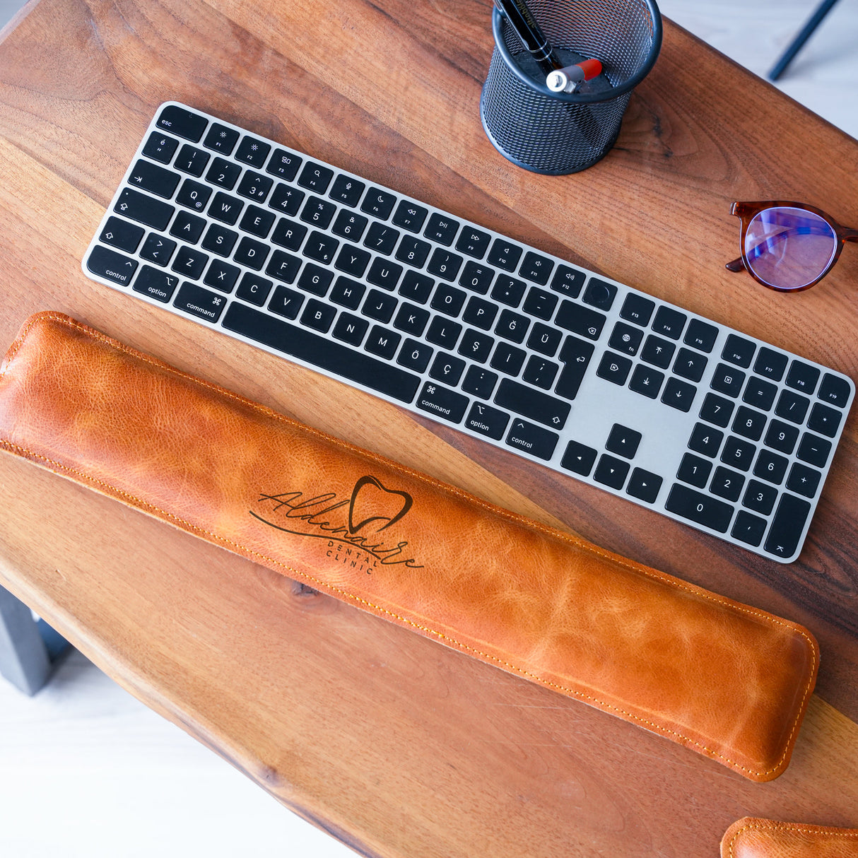 a computer keyboard sitting on top of a wooden desk