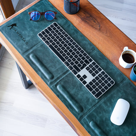 a desk with a keyboard, mouse and coffee cup